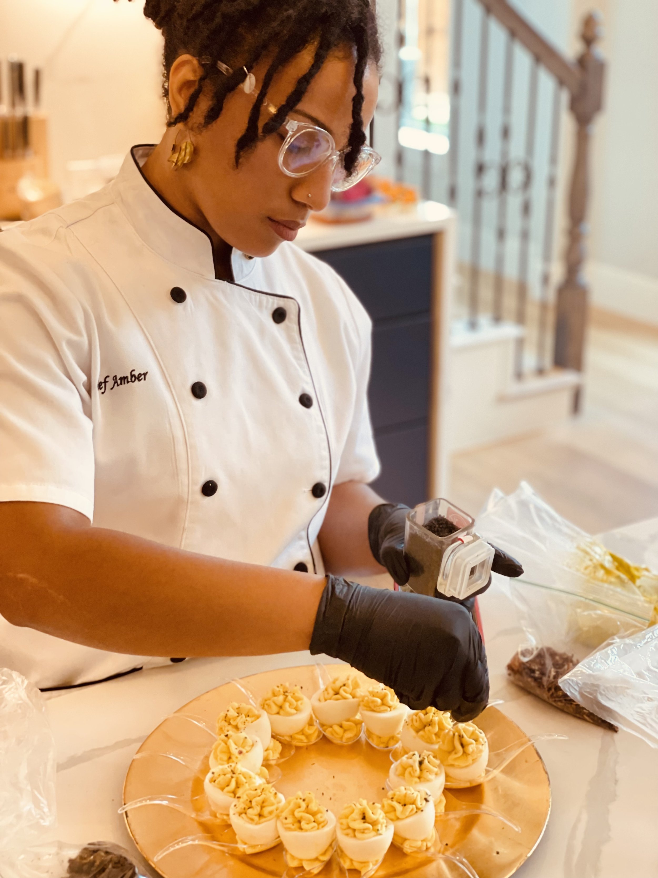 Chef Amber, of Le Rouge Cuisine garnishing devil egg dish